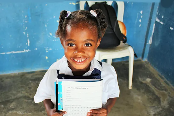 Ethiopian girl in school showing workbook