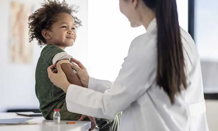 Little boy smiling after getting a shot