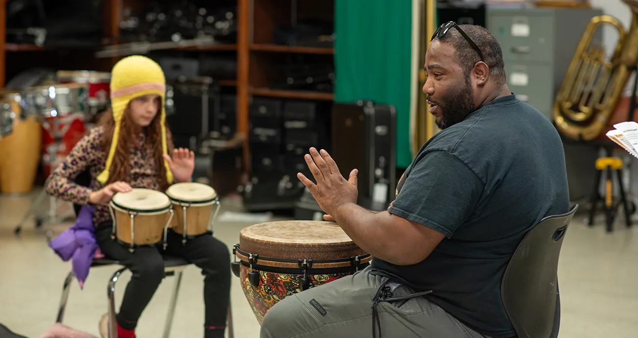 Teacher and student playing bongos