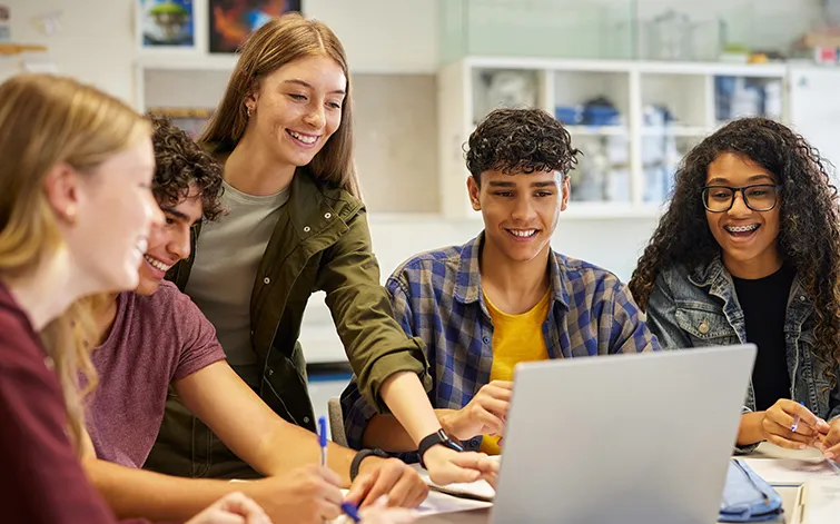 High school students working at a laptop