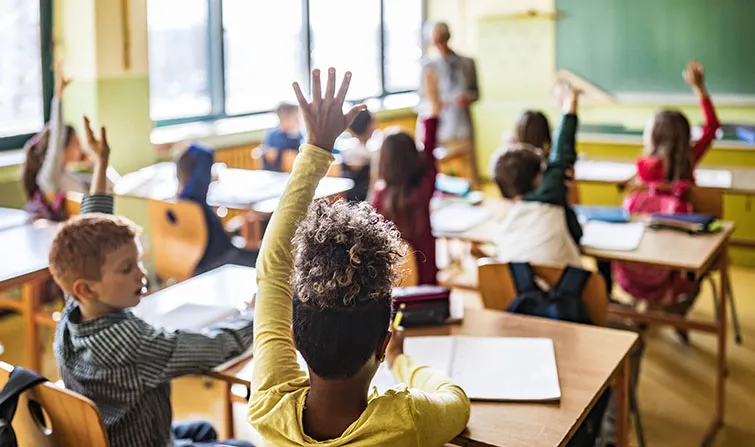Girl raising her hand in classroom