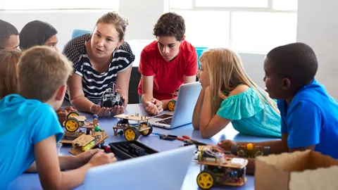 Students In After School Computer Coding Class Building And Learning To Program Robot Vehicle