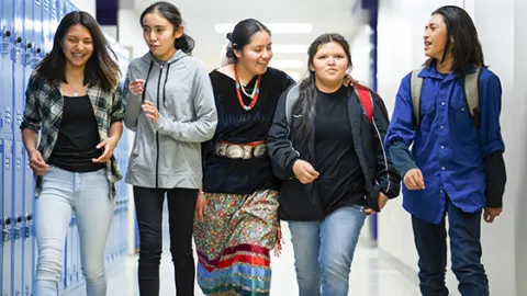 Native American students walking in school hallway