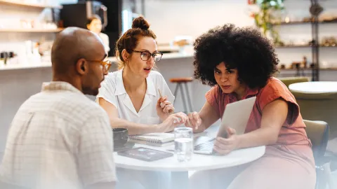 Colleagues working together at small table