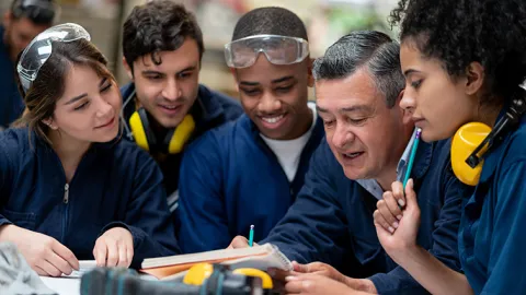 Factory workers with supervisor