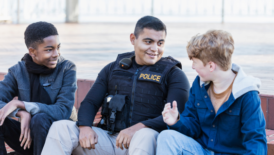 Police officer chatting with young people