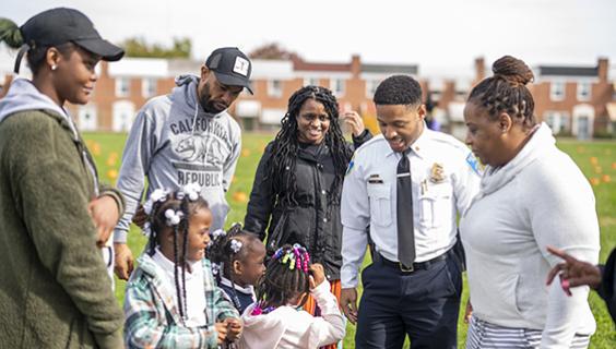 Baltimore police officer with community members