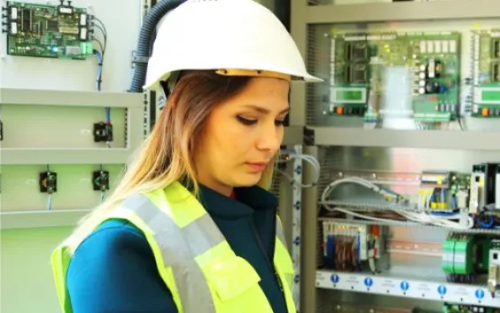 Female electrician working on an electrical panel