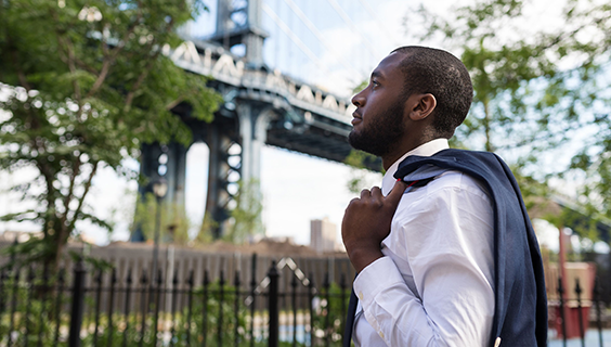 Pensive man looking at bridge in NY