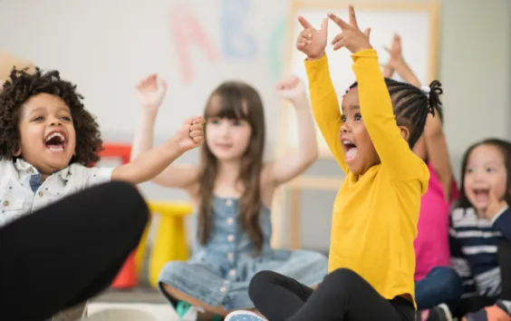 preschool children raising hands