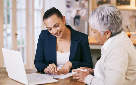 Older woman working with home health care professional