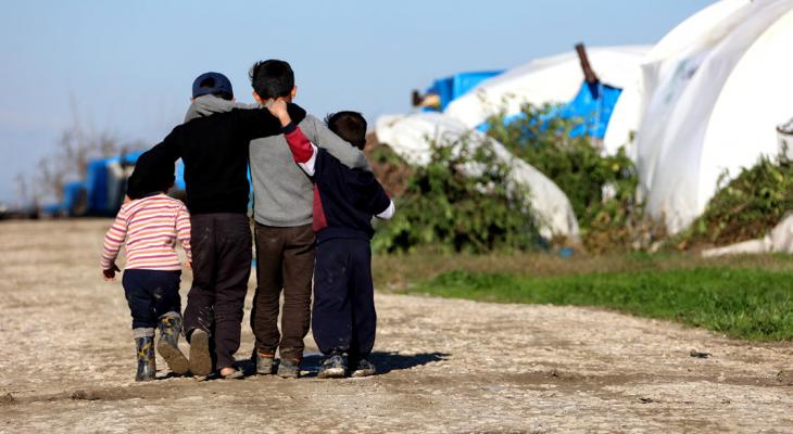 Refugee children walking arm in arm