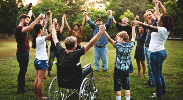 Group of people outside holding hands