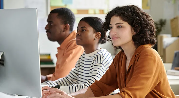 Young adults at a computer bank