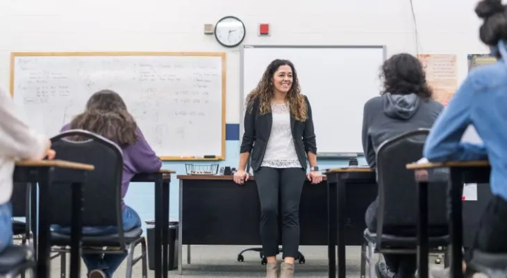 Teacher talking to students in math class.
