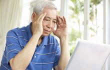 Image of confused older man at computer