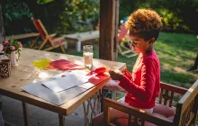 Image of elementary age child doing crafts outdoors