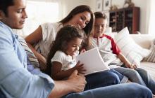 Image of Hispanic family reading together at home