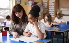 Teacher working closely with student