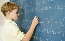 Boy doing math at chalkboard