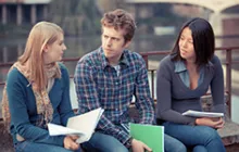 three college students in serious discussion