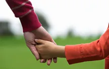 adult and child holding hands