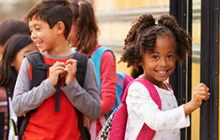 Image of young girl getting onto a school bus