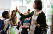 Image of teacher high-fiving a student 