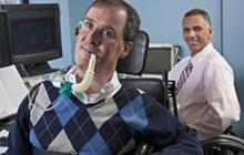 two workers with disabilities at computers
