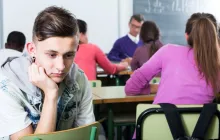 Sad teenager excluded in a classroom