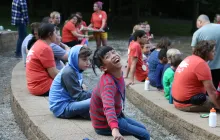 Girl at SeriousFun camp smiling with other campers