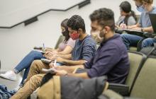 Masked college students in a classroom