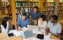 Adults working together in a library