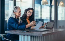 Two women analyzing work together