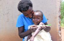 Boy having arm measured in Uganda