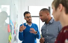 Coworkers collaborating at whiteboard