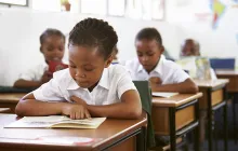 African child reading in a classroom
