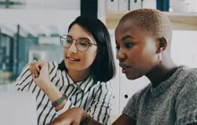 Colleagues work together at a laptop