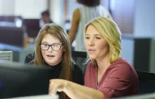 Visually impaired apprentice and mentor at computer