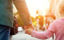man and child holding hands