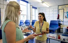 Two teachers talking in a classroom