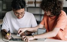 Two high school students working on technical project