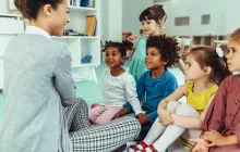 Teacher with young happy diverse students