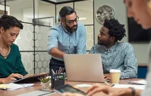 Colleagues discussing work in an office