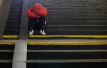 Sad teenager with head in his hands