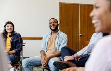 Smiling young people in a therapy group