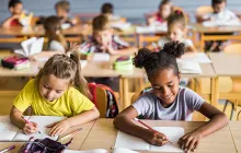 Elementary kids working at school desks