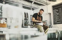 Bearded barista deep in thought