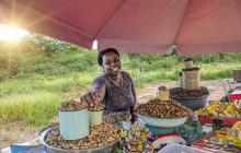 African woman selling peanuts in outdoor market