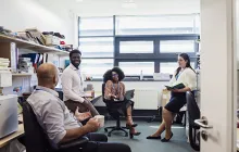 Group of colleagues talking in office